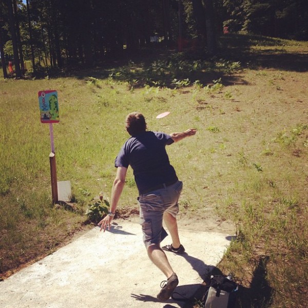 teeing off at the disc golf course