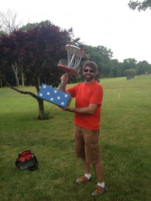 Winner, Christopher Jones holds the trophy from the 2013 Economy Open disc golf tournament.